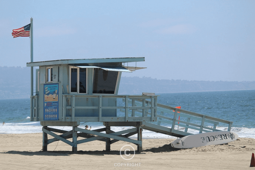 A lifeguard station overlooking the ocean—mirroring business leadership, resilience, and the ability to safeguard success amid changing tides.