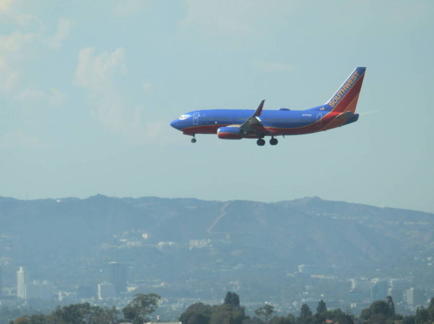 Southwest Airlines aircraft descending toward LAX with cityscape below, symbolizing strategic momentum for SME business growth